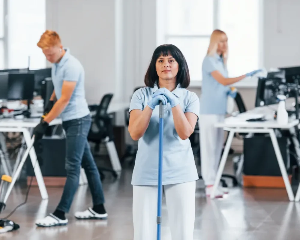 cleans-floor-group-of-workers-clean-modern-office-2023-11-27-04-49-39-utc (1)